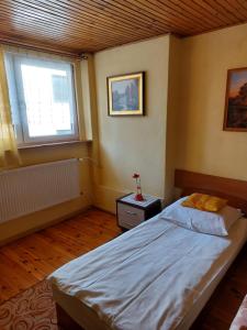 a bedroom with a large bed and a window at Noclegi-Pokoje goscinne Lublin in Lublin