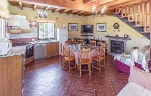 a kitchen with a table and chairs in a room at Cozy Home In Periana With House A Mountain View in Los Baños de Vilo