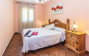 a bedroom with a large white bed and a table at Pet Friendly Home In Periana in Los Baños de Vilo