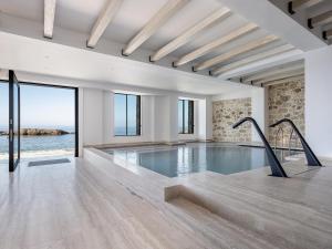 an indoor swimming pool with a view of the ocean at The Tanneries Hotel & Spa - a Member of Design Hotels in Chania +62 photos
