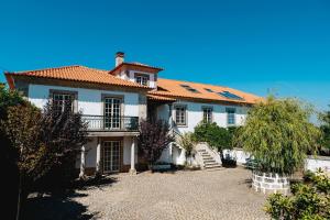 a large white house with a red roof at Feel Discovery Casa Da Capela Douro Valley Armamar in Armamar