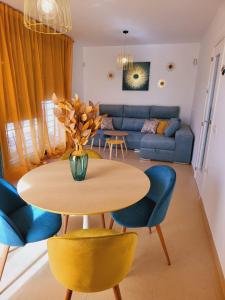 a living room with a table and chairs and a couch at La Paz del Mediterráneo in Garrucha