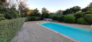 a swimming pool in the middle of a garden at LA MANOSC in Grimaud