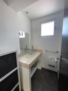 a bathroom with a sink and a mirror and a television at LA MANOSC in Grimaud +8 photos