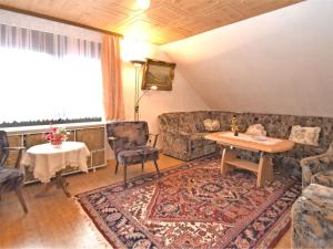 a living room with a couch and a table at Flat near the forest in Frauenwald Thuringia in Frauenwald