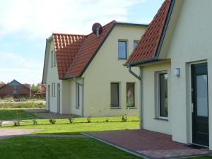 ein Haus mit einem roten Dach und einem Hof in der Unterkunft Holiday home in Wietzendorf in the L neburg Heath with a view of the countryside in Wietzendorf
