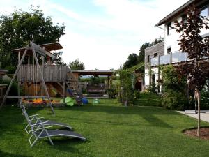 a yard with a playground with a slide at Modern Apartment near Forest in Heinrichskirchen in Heinrichskirchen