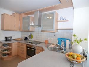 a kitchen with a sink and a bowl of fruit on a counter at Apartment in Hauzenberg with private terrace in Hauzenberg