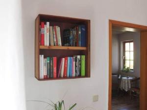 una mensola su un muro con libri di Apartment in Tabarz Thuringia near the forest a Tabarz