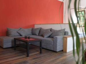 a living room with a couch and a table at Apartment in Tabarz Thuringia near the forest in Tabarz