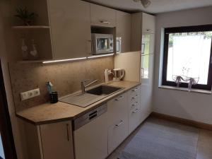 a kitchen with a sink and a counter top at Holiday home in the Bavarian Forest in Schöfweg