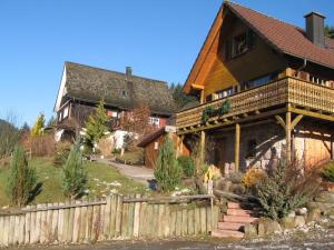 a large wooden house with a fence in front of it at Magnificent Holiday Home in Reinerzau with Sauna in Alpirsbach