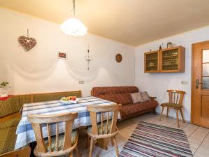 a living room with a table and a couch at Delightful Holiday Home in Unterammergau with Terrace in Unterammergau