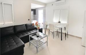 a living room with a black couch and a table at Awesome Apartment In Alicante With Wifi in Alicante