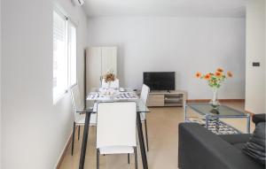 a living room with a table and a couch at Awesome Apartment In Alicante With Wifi in Alicante