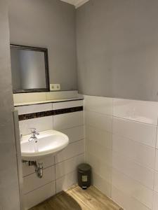 a bathroom with a sink, toilet, and bathtub at Family Apartments Lübeck in Lübeck