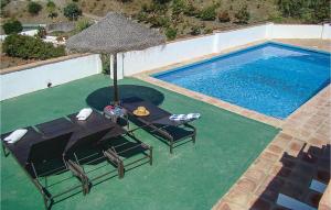 an overhead view of a pool with a table and an umbrella at Gorgeous Home In El Borge With Outdoor Swimming Pool in Borge