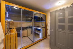 a glass shower in a room with a door at Villa 72 Crikvenica Riviera in Bribir