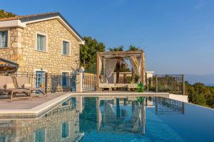 a swimming pool in front of a house at Villa 72 Crikvenica Riviera in Bribir