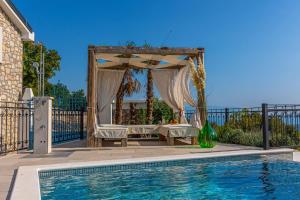 a gazebo with a bed and a pool at Villa 72 Crikvenica Riviera in Bribir +29 photos