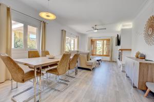 a dining room and living room with a table and chairs at Villa Maravillas 2 by Slow Villas in El Arenal