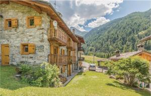 an image of a house with mountains in the background at Valsavarenche in Maisonasse