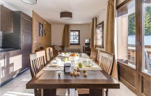 a dining room with a long wooden table with chairs at Les Fermes miguy in Les Gets