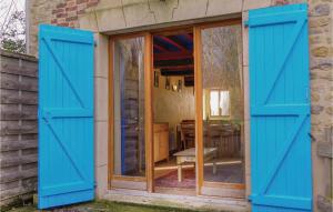 eine Tür mit blauen Rollläden an einem Haus in der Unterkunft 2 Bedroom Awesome Home In Brucheville in Brucheville