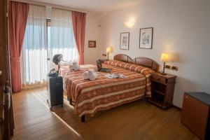 Postel nebo postele na pokoji v ubytování HG Hotel Italia