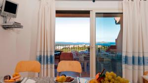 a dining room with a view of the ocean at Residence Floreal in San Pasquale