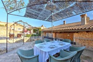 a dining room with a white table and chairs at Villa Can Pulit by Slow Villas in El Port de la Selva