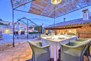 a dining room with a table and chairs on a patio at Villa Can Pulit by Slow Villas in El Port de la Selva