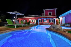 a swimming pool in front of a house at night at Villa Segundo by Slow Villas in Llucmajor
