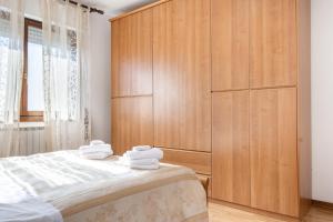a bedroom with a large wooden cabinet next to a bed at Ponte San Giovanni Terrace Apartment in Ponte San Giovanni