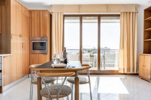 a kitchen with a table and chairs with a window at Ponte San Giovanni Terrace Apartment in Ponte San Giovanni