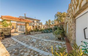a courtyard with a stone walkway in a house at Cozy Home In Puig Ventos With Outdoor Swimming Pool in Mont Barbat