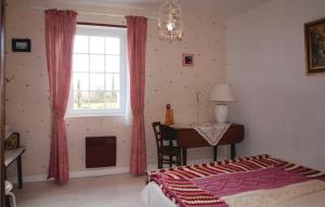 1 dormitorio con cama, escritorio y ventana en Stunning Home In Plouha With Kitchen en Plouha