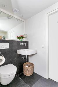 a bathroom with a toilet and a sink at B&B Van Gogh Cottage in Nuenen