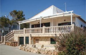 a white house with a porch and a balcony at Cozy Home In Ses Covetes With Wifi in Ses Covetes