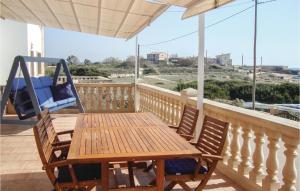 a porch with a hammock and a wooden table and chairs at Cozy Home In Ses Covetes With Wifi in Ses Covetes