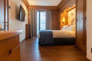 Postel nebo postele na pokoji v ubytování Faloria Mountain Spa Resort