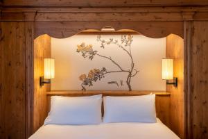 Postel nebo postele na pokoji v ubytování Faloria Mountain Spa Resort