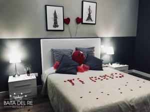 a bedroom with a bed with red hearts on it at La Baita Del Re Resort in Ottaviano