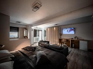 a living room with a couch and a tv on the wall at Shiro in Bucharest