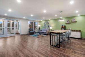 a large living room with a table and chairs at WoodSpring Suites Tampa Airport North Veterans Expressway in Tampa