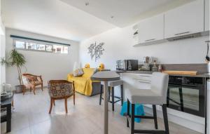 a kitchen and living room with a table and chairs at Lovely Apartment In La Grande-Motte in La Grande-Motte