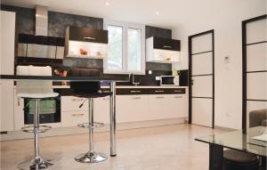 cocina con armarios blancos y encimera negra en Nice Home In Ville Di Paraso With Wifi, en Ville-di-Paraso