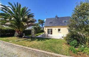a house with a palm tree in front of it at Stunning Home In Plouguerneau With 3 Bedrooms And Wifi in Plouguerneau