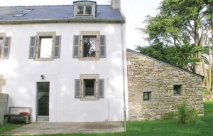 a white house with a stone wall at Gorgeous Home In Mahalon With Kitchen in Mahalon