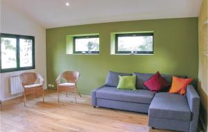 a living room with a blue couch with colorful pillows at Gorgeous Home In Mahalon With Kitchen in Mahalon +16 photos